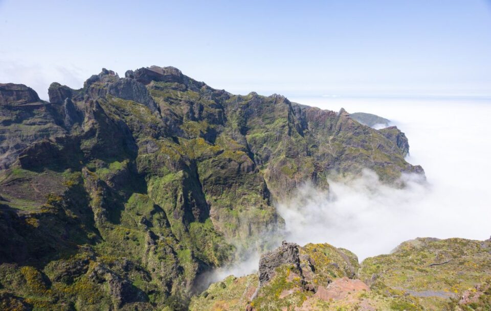 Pico do Areeiro peak with rugged mountain landscape and clouds in Madeira.