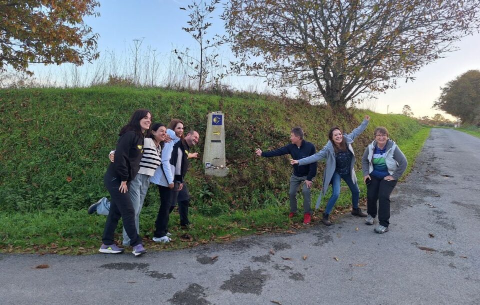 Walkers around a Camino marker, Ingles