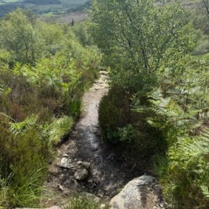 Climbing down boulders onto path - Arran